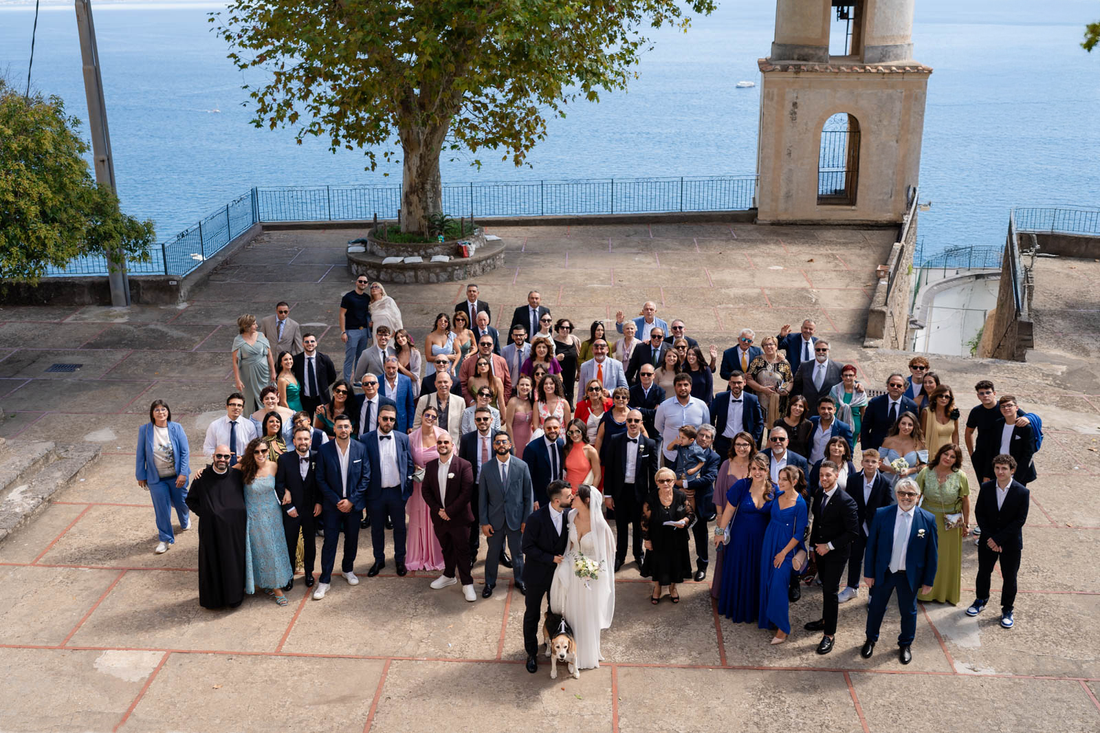 Elegant wedding reception setup with an Amalfi Coast backdrop