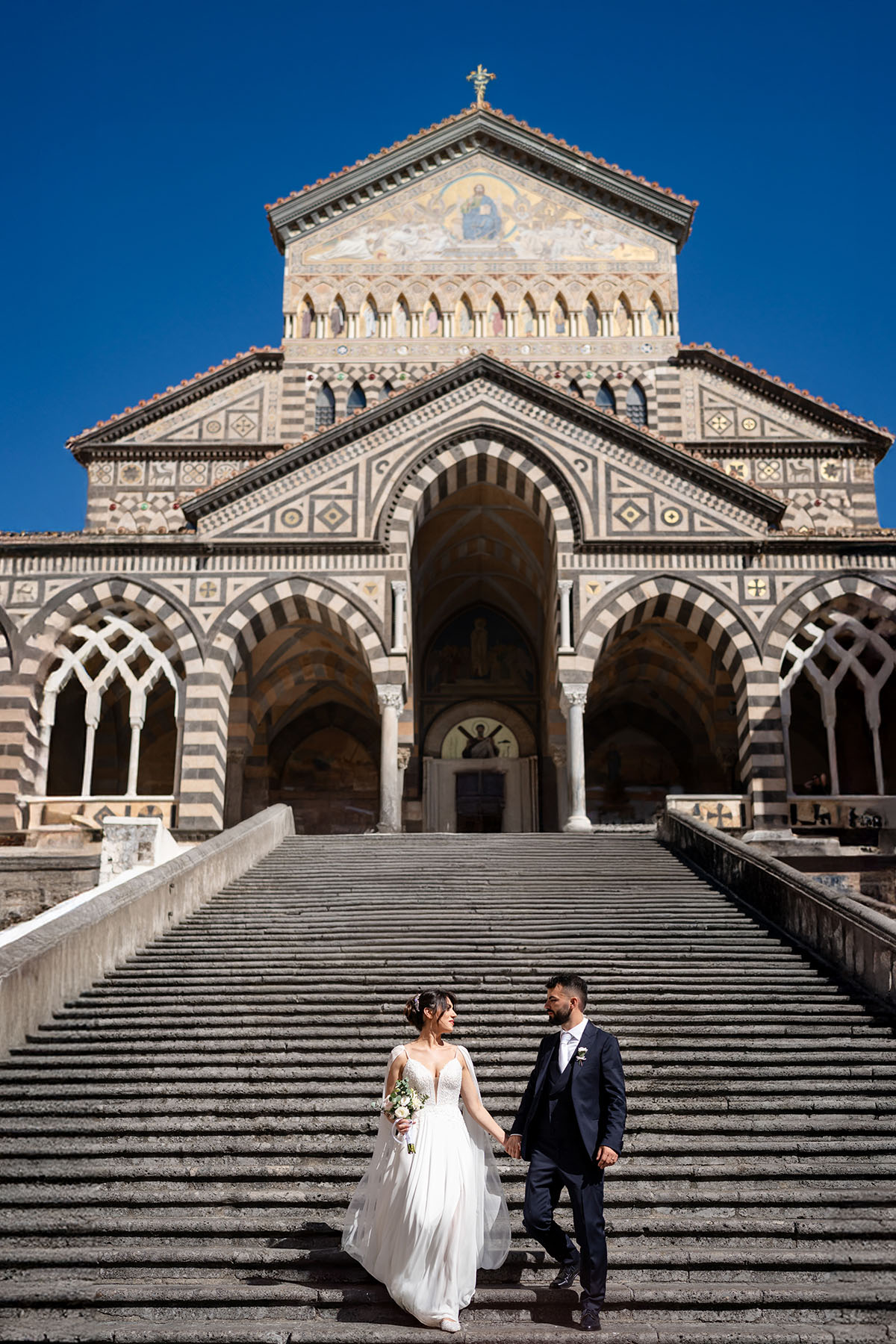 Bride’s wedding dress flowing as she walks down the aisle in Amalfi