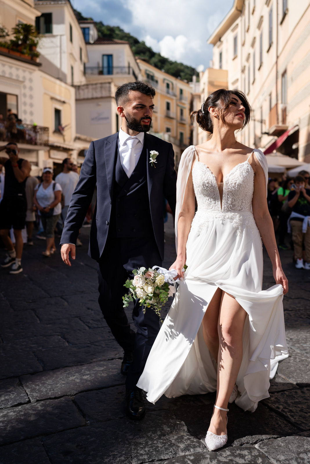 Bride walking down a historic staircase in Amalfi